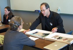 Glenn Ruga reviewing portfolio at the 2012 New England Portfolio Reviews. Photo by Robert Hunt.