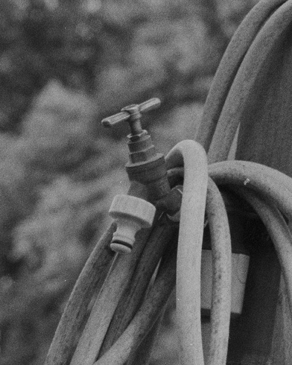 detail of hose coiled on a fence