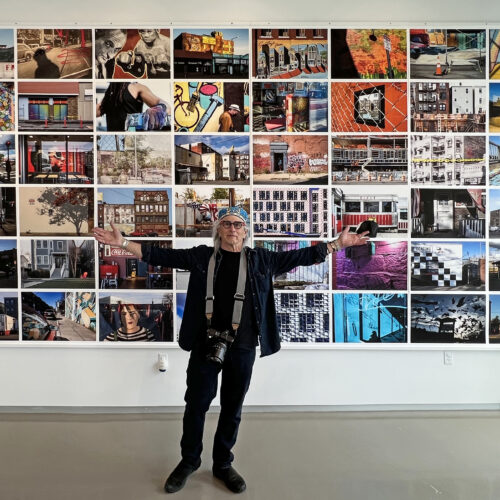 Edward Boches in front of a wall of his images hung with DSI Wood Print Hangers.