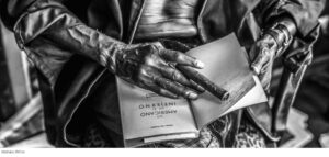 Mathieu Bitton image of hands holding a book and cigar