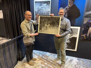 Matt Eich and Eric Luden hold a DSI Digital Silver Print® of Matt Eich's black and white image.